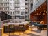 Luxurious outdoor lounge with modern bar seating, ambient lighting, and stylish seating area in a chic apartment complex.