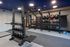 Modern fitness center with state-of-the-art gym equipment, including kettlebells, punching bag, stability balls, and pull-up bars, offering a comprehensive workout experience.
