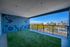 Spacious balcony with vibrant mural and stunning city views, perfect for relaxation and enjoying the skyline.