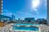 Luxurious rooftop pool with sun loungers and city skyline views, perfect for relaxation and urban enjoyment.