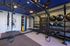 Modern home gym featuring a punching bag, exercise balls, medicine balls, and versatile workout equipment for comprehensive fitness.