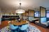 Modern communal lounge with stylish seating, contemporary lighting, and vibrant mixed-use tables. Ideal for social gatherings and collaborative work in a sleek, inviting atmosphere.