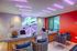 Modern reception area with vibrant neon lighting, stylish seating, and a welcoming ambiance at Aspire.