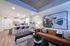 Modern open-concept living space with a sleek kitchen, stylish seating area, and contemporary artwork, ideal for a luxurious lifestyle.