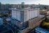 Modern urban apartment building with stylish architecture and vibrant city views, perfect for contemporary living.