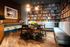 Cozy apartment nook with stylish bookshelves, comfortable seating, and elegant dining area.