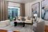 Elegant living room with modern decor featuring a plush sofa, stylish armchairs, and abstract artwork, offering a cozy ambiance with a view of the cityscape.