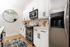 Modern kitchen with sleek stainless steel appliances, elegant white cabinetry, and a stylish backsplash, perfect for culinary enthusiasts.