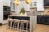 Elegant modern kitchen with stunning marble island, stylish pendant lighting, and high-end appliances.