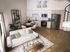 Modern apartment interior highlighting an open-concept kitchen and living area with sleek cabinetry, stainless steel appliances, and cozy seating on elegant wooden flooring.