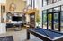 Luxurious open-concept lounge featuring chic decor, elegant lighting, a pool table, and a vibrant mural, perfect for entertaining.