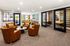 Elegant communal space with modern leather chairs, cozy seating arrangements, and serene natural lighting, offering a perfect blend of comfort and style.