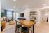Modern open-concept living area with a stylish wooden table, cozy seating, and elegant decor accents, perfect for entertaining.