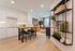 Chic apartment interior showcasing an elegant open-plan kitchen with modern cabinetry, sleek breakfast bar, and cozy living area with stylish decor.