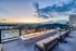 Breathtaking rooftop terrace with cozy fire pit and stunning cityscape views at sunset.