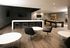 Sophisticated recreational area with modern seating, sleek bar, large screen TVs, and a stylish pool table.