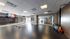 Spacious exercise studio with mirrored walls, hardwood floors, and modern fitness equipment, perfect for yoga or dance.