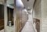 Modern apartment mailroom featuring sleek brown mailboxes, stylish stone accent wall, and inviting lighting.