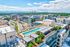 Stunning rooftop view showcasing a luxurious pool, modern architecture, and vibrant cityscape.