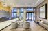 Elegant lobby area featuring modern chandeliers, a sleek reception desk, and stylish seating with floor-to-ceiling windows.