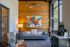 Chic modern living room featuring a gray sofa, vibrant geometric artwork, and a cozy ambiance with natural wood accents.