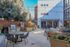 Charming outdoor patio featuring stylish seating, string lights, and a modern barbecue area, perfect for entertaining.