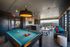Chic rooftop lounge with a pool table, modern seating, and breathtaking city skyline views.