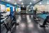 Modern fitness center with sleek exercise bikes, vibrant therapy balls, and a full wall of mirrors for an energizing workout.