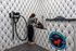 Modern pet grooming station with stylish black and white patterned walls, featuring a dedicated wash area and pet-friendly amenities.