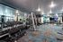 Modern fitness center featuring state-of-the-art gym equipment, mirrored walls, and a vibrant atmosphere.