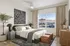 Serene bedroom with modern decor, featuring a cozy bed, elegant artwork, and panoramic mountain views through a large window. Chic furnishings and natural light create a calming ambiance.