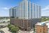 Modern high-rise apartment building with sleek design and numerous windows, offering urban living and spectacular city views.