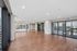 Expansive modern dance studio with floor-to-ceiling windows offering stunning city views and abundant natural light.