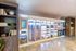 Modern common area with stylish shelving and a sleek rental station offering various household items and snacks.