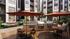 Luxe apartment courtyard featuring stylish outdoor seating, vibrant umbrellas, and modern grills, surrounded by lush greenery.