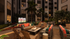 Luxurious outdoor lounge area with a cozy fire pit, vibrant seating, palm trees, and a large screen for entertainment in a sophisticated apartment complex.