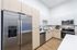 Modern kitchen with sleek stainless steel appliances, elegant light wood cabinetry, and a stylish open layout.