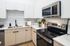 Modern kitchen with sleek stainless steel appliances, white cabinetry, and chic subway tile backsplash, perfect for culinary enthusiasts.