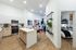 Modern apartment interior showcasing a sleek kitchen with wooden cabinetry, an inviting open-plan living area, and a cozy, elegantly styled bedroom.