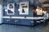 Chic and contemporary cafe-style space featuring modern bar stools, elegant hanging lights, and abstract wall art.