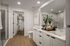 Modern bathroom with elegant vanity, spacious walk-in shower, and cozy walk-in closet.
