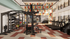 Modern gym with vibrant wall art, featuring state-of-the-art fitness equipment including treadmills, weight racks, and training machines, all bathed in natural light.