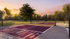Luxurious tennis court at sunset surrounded by lush greenery, offering a serene recreational space.