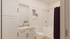 Elegant bathroom featuring sleek cabinetry, a stylish countertop, and a luxurious bathtub with modern fixtures.