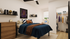 Chic bedroom with cozy bed, stylish decor, and spacious closet, featuring wooden accents and natural light.