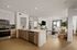 Modern open-concept apartment featuring a sleek kitchen, cozy living room, and stylish decor with natural light.
