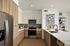 Modern kitchen with sleek wood cabinetry, stainless steel appliances, and elegant countertops, perfect for culinary creativity.