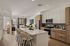 Modern open-concept kitchen and living area with stylish island seating and sleek cabinetry.