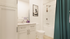 Elegant bathroom with modern fixtures, sleek vanity, and inviting bathtub, enhanced by stylish teal accents.
