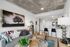 Chic modern living room with stylish decor, cozy seating, and open layout extending to a sleek kitchen bar.